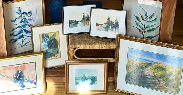 A collection of original watercolor art in frames