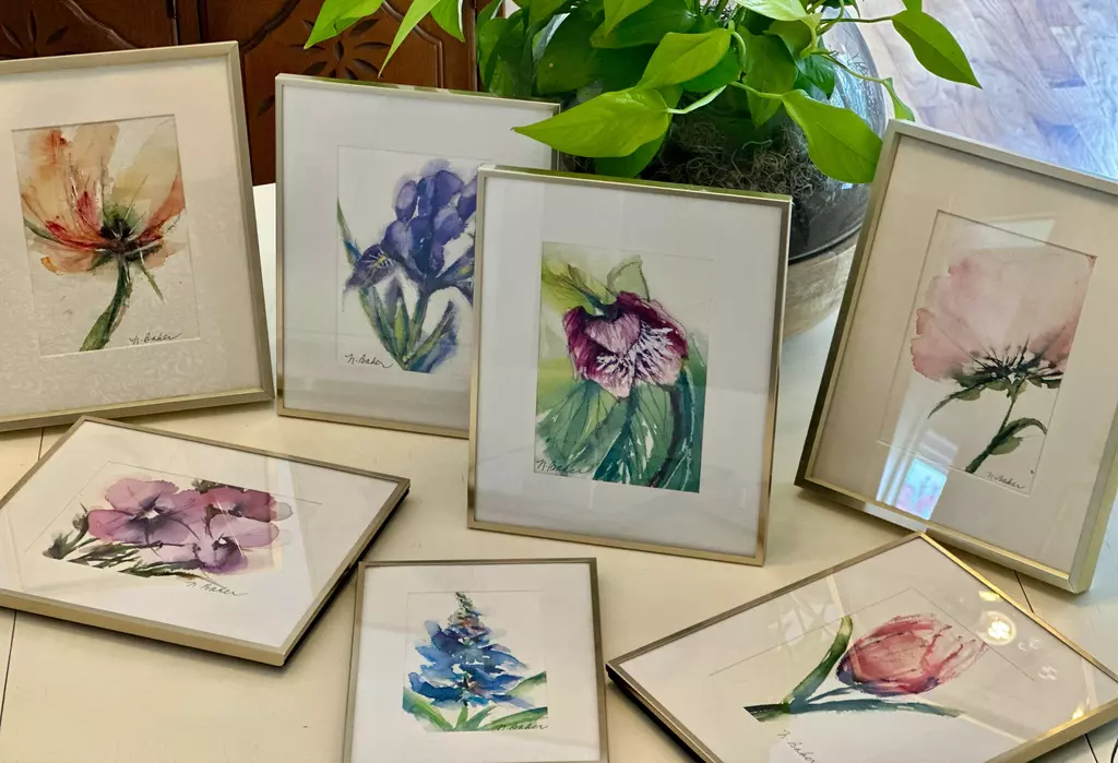 Collection of framed tabletop watercolor art in frames
